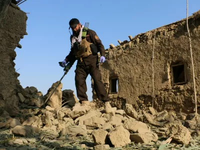 A member of Taliban security forces uses a metal detector amid the rubble of a house that was damaged in what the Taliban said was a Pakistani airstrike in Gurbuz district of Khost province, Afghanistan, September 24, 2026. REUTERS/Stringer