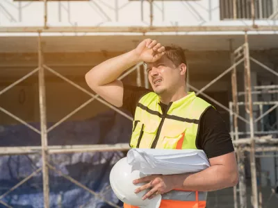 Male construction engineer worker working feeling tired and thirst of water at construction site