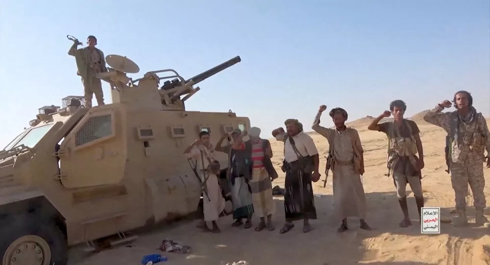 FILE PHOTO: Iran-aligned Houthi fighters pose next to a captured vehicle following what the source described as an attack on Saudi-backed forces in the location given by the source as al Jawf governorate, Yemen, in this screengrab taken from a video released by Houthi Military Media on September 15, 2026. HOUTHI MILITARY MEDIA/Handout via REUTERS. THIS IMAGE HAS BEEN SUPPLIED BY A THIRD PARTY. Verification Lines: Reuters could not verify the location or exact date when the video was filmed. However, no older versions of the video were found posted online before September 15./File Photo
