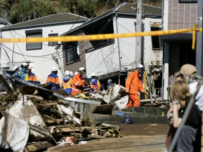 Rescue workers conduct a rescue and search operation for a missing person at a house hit by a landslide triggered by Typhoon Dujuan in Miura, Kanagawa Prefecture, Japan, September 22, 2026, in this photo taken by Kyodo. Mandatory credit Kyodo/via REUTERS ATTENTION EDITORS - THIS IMAGE HAS BEEN SUPPLIED BY A THIRD PARTY. MANDATORY CREDIT. JAPAN OUT. NO COMMERCIAL OR EDITORIAL SALES IN JAPAN.