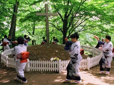 - FILE PHOTO 6JUN99 - Kimono-clad local women perform a traditional folk dance around a grave with a cross in northern Japanese town of Shingo in this file photo taken June 6. Locals believe that, contrary to what the Bible says, Jesus Christ died not on Calvary but in this remote northern Japanese town among mountains and rice fields, his previously unheard-of younger brother crucified in his place instead.