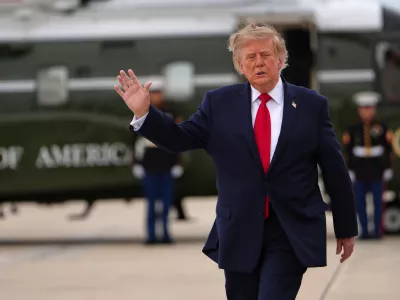 President Donald Trump waves as he walks from Marine One to board Air Force One, Saturday, Sept. 26, 2026, at Joint Base Andrews, Md. (AP Photo/Julia Demaree Nikhinson)