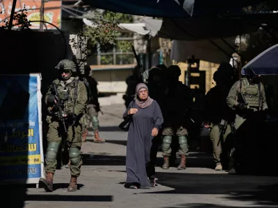 Israeli soldiers take positions during a military operation at a market in Nablus, West Bank, Sunday, Sept. 27, 2026. (AP Photo/Majdi Muhammad)