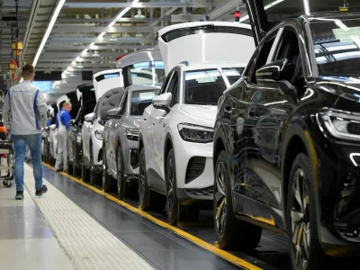 FILE PHOTO: Technicians work at the production line for electric car models of the Volkswagen Group in Zwickau, Germany, April 26, 2022. REUTERS/Matthias Rietschel/File Photo