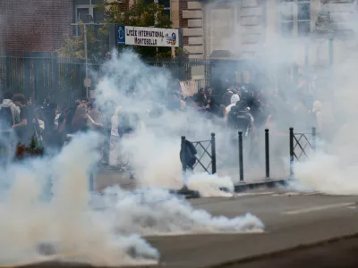 Riot police throw tear gas as high school students block the entrance of a school during a protest to demand more resources for schools, in Lille, France, Wednesday, Sept. 30, 2026. (AP Photo/Jean-Francois Badias)