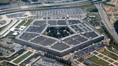 Aerial view of the Pentagon complex with surrounding roads, parking and greenery. g.
