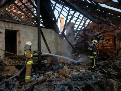 Firefighters work in the attic of a residential building that caught fire after it was struck by a Russian jet-powered drone, amid Russia's attack on Ukraine, in Kyiv, Ukraine, September 29, 2026. REUTERS/Thomas Peter