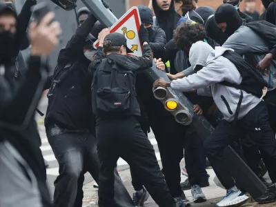 Students tear down a traffic light next to the Baggio High School, blocked in protest of the government's release of next year's draft budget, in Lille, France, Tuesday, Sept. 29, 2026. (AP Photo/Jean-Francois Badias)