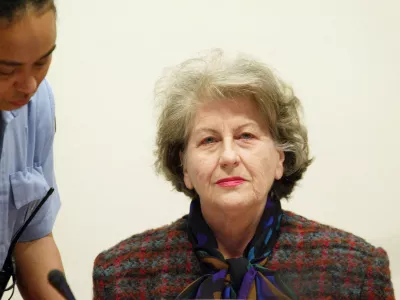 Ex-Bosnian Serb President Biljana Plavsic (R) is escorted by a United Nations security guard at the beginning of her sentencing hearing at the U.N. International Criminal Tribunal for the former Yugoslavia, in The Hague, December 16, 2002. The former biology professor had initially pleaded innocent to multiple counts of genocide, crimes against humanity and war crimes after surrendering to the U.N. court in January 2001. Plavsic, 72, changed her plea in October to guilty on one charge of persecution in what lawyers said was a move "expressing her remorse fully and unconditionally". REUTERS/Fred Ernst/Pool