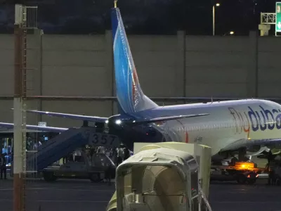 People disembark from a FlyDubai carrying Israeli passengers who had earlier been aboard another FlyDubai aircraft that made an emergency landing in Saudi Arabia approaches Ben Gurion International Airport near Tel Aviv, Israel, Wednesday, Sept. 30, 2026. (AP Photo/Ariel Schalit)