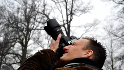 Professional photographer focusing digital camera