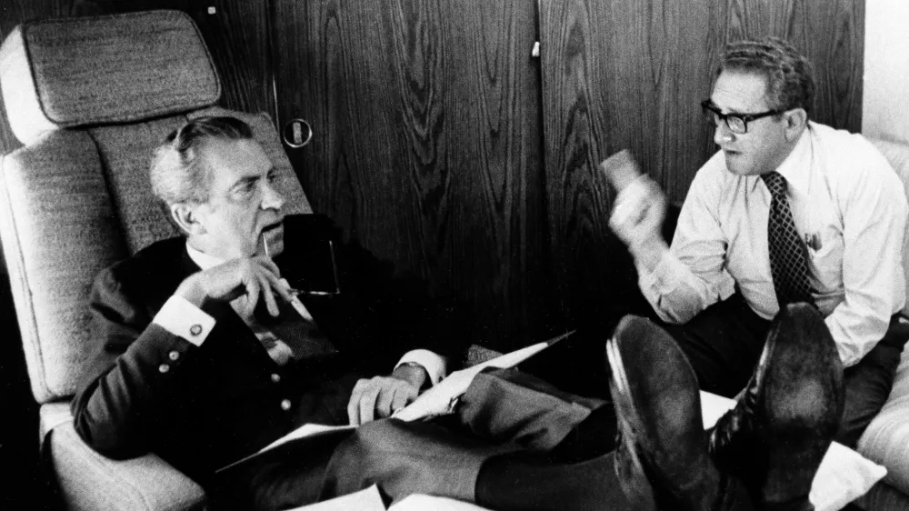 FILE - In this June 25, 1974, photo released by the White House, President Richard Nixon listens to his Secretary of State Dr. Henry Kissinger aboard the plane that brought the U.S. president to Belgium. Within two months Nixon had resigned, and in June 1975, the feisty ex-President defended his shredded legacy and shady Watergate-era actions in grand jury testimony that he thought would never come out. On Thursday, Nov. 10, 2011, it did. (AP Photo/White House Photo, Ollie Akins)
