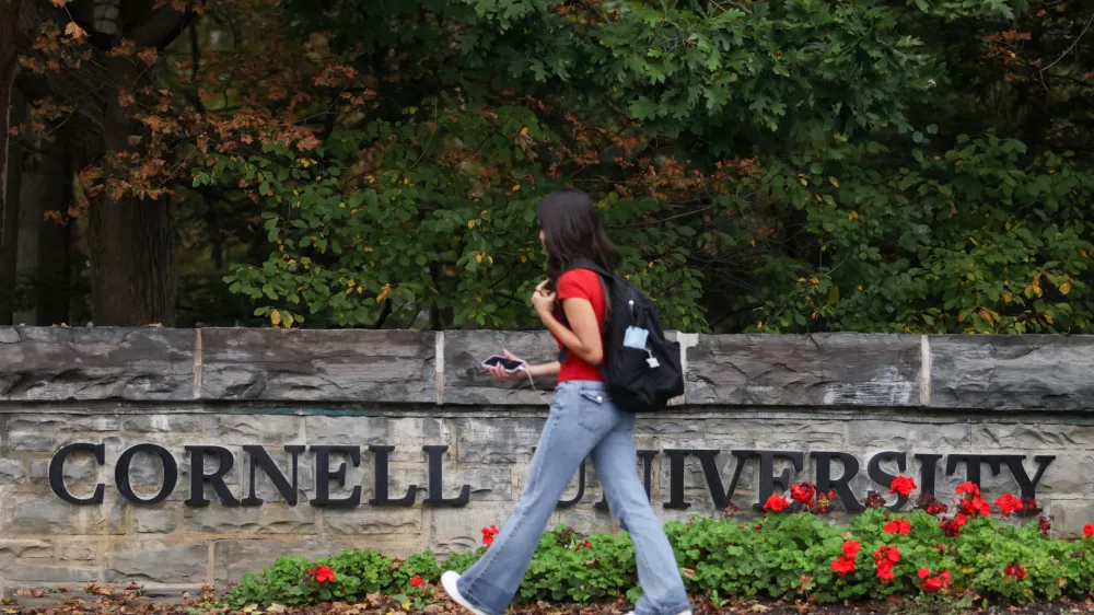 A student walks by a sign at the entrance of Cornell University in Ithaca, New York, US, October 1, 2026. REUTERS/Lauren Petracca