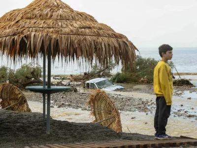 A boy stands by a damaged beach bar, after heavy rain continues to affect parts of Crete, prompting authorities to maintain severe weather warnings, in Therma near Ierapetra, Crete island, Greece, October 3, 2026. REUTERS/Stefanos Rapanis   TPX IMAGES OF THE DAY