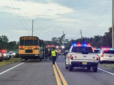 In this photo provided by the Polk County Sheriff's Office, emergency personnel respond to an accident involving a school bus in Winter Haven, Fla., on Monday, Oct. 5, 2026. (Polk County Sheriff's Office via AP)