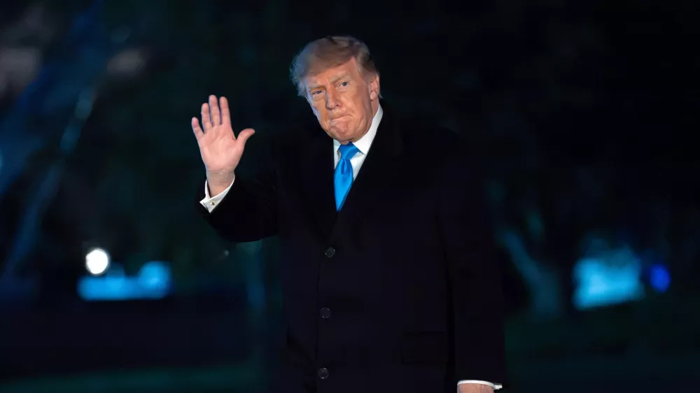 President Donald Trump waves to reporters as he walks on the South Lawn upon his arrival at the White House, Monday, Oct. 5, 2026, in Washington. (AP Photo/Jose Luis Magana)