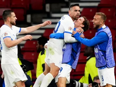 Slovenia's Aljosa Matko, center left, celebrates scoring with teammates during the Nations League soccer match between Scotland and Slovenia in Glasgow, Scotland, Tuesday Oct. 6, 2026. (Andrew Milligan/PA via AP)