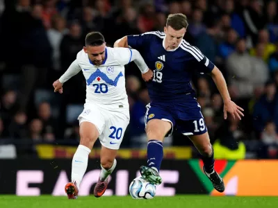 Slovenia's Aljosa Matko, left, and Scotland's Lewis Ferguson battle for the ball during the Nations League soccer match between Scotland and Slovenia in Glasgow, Scotland, Tuesday Oct. 6, 2026. (Andrew Milligan/PA via AP)