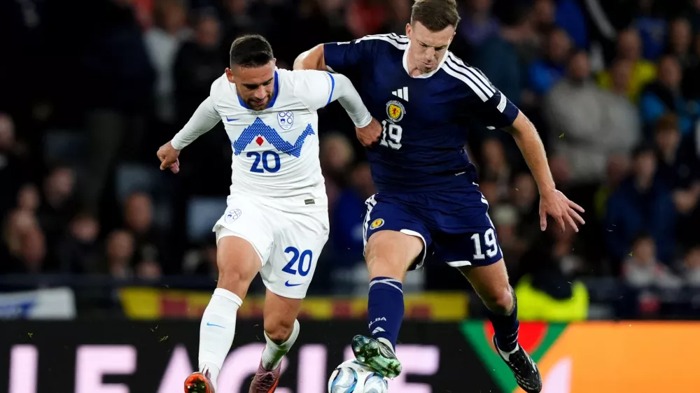 Slovenia's Aljosa Matko, left, and Scotland's Lewis Ferguson battle for the ball during the Nations League soccer match between Scotland and Slovenia in Glasgow, Scotland, Tuesday Oct. 6, 2026. (Andrew Milligan/PA via AP)
