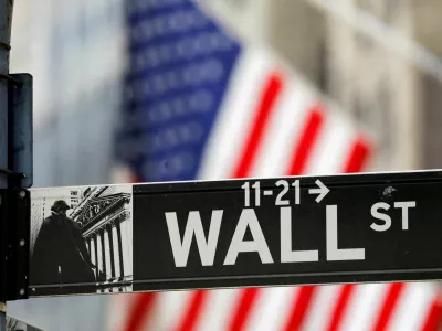 FILE PHOTO: A street sign for Wall Street is seen outside the New York Stock Exchange (NYSE) in New York City, New York, U.S., July 19, 2021. REUTERS/Andrew Kelly/File Photo
