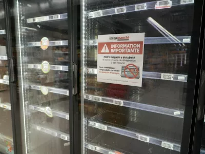 View of empty refrigerators at the frozen food aisle inside an Intermarche supermarket in Paris the day after a cyberattack targeted refrigeration systems at French supermarket chains, causing food losses and fires at several stores, France, October 13, 2026. The placard reads "Important information. Our store has been hacked, and our refrigeration system has been affected." REUTERS/Lucien Libert
