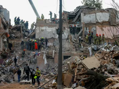 Emergency services work to rescue residents from under the debris at the site of an apartment building which was hit by a Russian missile strike in the town of Pryluky, amid Russia's attack on Ukraine, in the Chernihiv region, Ukraine, October 7, 2026. REUTERS/Valentyn Ogirenko