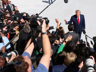 President Donald Trump speaks to reporters before boarding Marine One at the White House on Wednesday, Oct. 7, 2026, in Washington. (AP Photo/Tom Brenner)