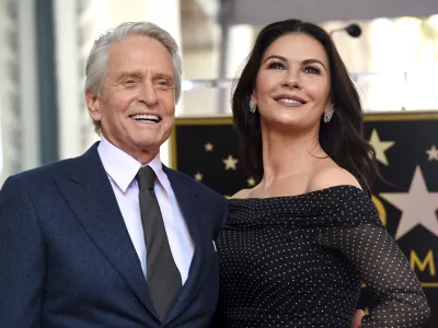 FILE - Actor Michael Douglas, left, and his wife Catherine Zeta-Jones appear at a ceremony honoring him with a star on the Hollywood Walk of Fame in Los Angeles on Nov. 6, 2018. (Photo by Chris Pizzello/Invision/AP, File)