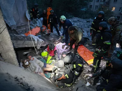 Rescue workers pull a family from the rubble of a residential building destroyed by a Russian airstrike in Zaporizhzhia, Ukraine, Saturday, Oct. 10, 2026. (AP Photo/Kateryna Klochko)
