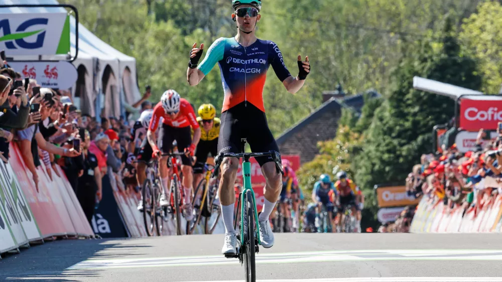 Paul Seixas of France crosses the finish line ahead of Mauro Schmid of Switzerland, rear left, and Ben Tulett of Britain, rear in yellow, to win the Belgian cycling classic Fleche Wallonne (Walloon Arrow), in Huy, Belgium, Wednesday, April 22, 2026. (AP Photo/Geert Vanden Wijngaert)