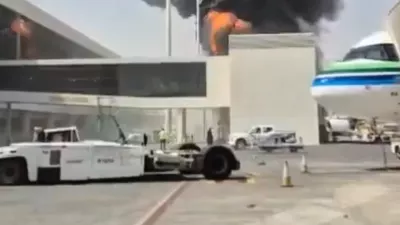 This image from video obtained and verified by AP shows thick black smoke and flames rising from a fire at King Khalid International Airport in Riyadh, Saudi Arabia, Friday, Oct. 9, 2026. (UGC via AP)