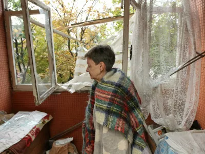 A woman stands inside her apartment in a residential building that was hit by a Russian drone strike, amid Russia's attack on Ukraine, in Dnipro, Ukraine, October 11, 2026. REUTERS/Stringer