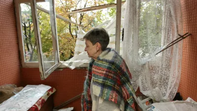 A woman stands inside her apartment in a residential building that was hit by a Russian drone strike, amid Russia's attack on Ukraine, in Dnipro, Ukraine, October 11, 2026. REUTERS/Stringer