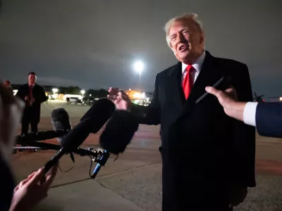 President Donald Trump speaks with reporters as he arrives on Air Force One, Saturday, Oct. 10, 2026, at Joint Base Andrews, Md. (AP Photo/Alex Brandon)