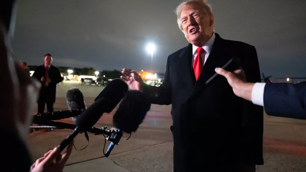 President Donald Trump speaks with reporters as he arrives on Air Force One, Saturday, Oct. 10, 2026, at Joint Base Andrews, Md. (AP Photo/Alex Brandon)