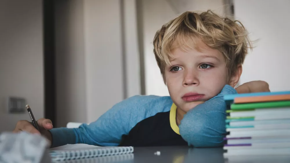 little boy tired exhausted stressed of reading, doing homework