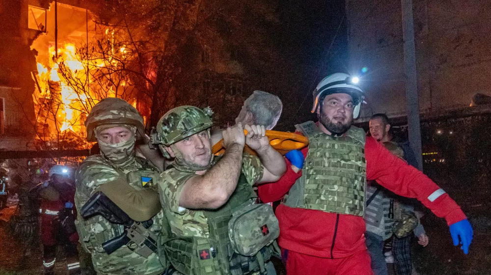 Rescuers evacuate an injured civilian after a residential building was hit following a Russian air attack in Kharkiv, Ukraine, Tuesday, Oct. 13, 2026. (AP Photo/Andrii Marienko)