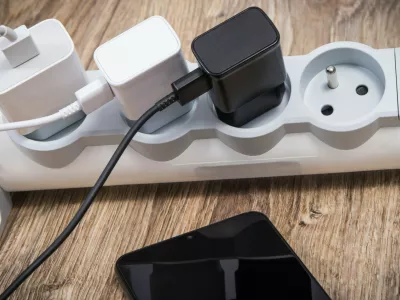 Smartphone, mobile phone and chargers connected to electrical power strip. Various devices charging concept. Smartphone and chargers connected to electrical power strip. Various devices charging concept,Image: 1129613115, License: Royalty-free, Restrictions:, Model Release: no 