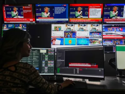 FILE -Screens at Turkish Halk TV news channel headquarters display Turkish President and People's Alliance's presidential candidate Recep Tayyip Erdogan, top, speaking during a rally, in Istanbul, Turkey, May 5, 2023. (AP Photo/Emrah Gurel, File)