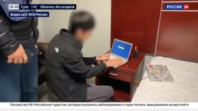 A view of the arrest of a person, identified by Russia's Federal Security Service (FSB) as a Japanese journalist for the Hokkaido Shimbun newspaper and accused of gathering information on Russia's defence capabilities, at an unidentified location, in this still image taken from a video aired by Rossiya-24 (RU24) state TV channel and released October 13, 2026. Rossiya-24/Handout via REUTERS ATTENTION EDITORS - THIS IMAGE HAS BEEN SUPPLIED BY A THIRD PARTY. NO RESALES. NO ARCHIVES. MANDATORY CREDIT. BLURRING AND OVERLAYS FROM SOURCE.
