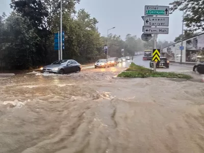 Vehicles drive along a partially flooded road during a heavy rain in Istanbul, Turkey, Wednesday, Oct. 14, 2026. (Omer Hamza Yildiz/DIA Photo via AP)
