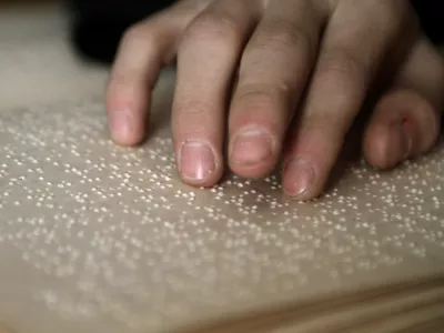 A blind boy reads a Braille book in a classroom in Tbilisi March 19, 2010. Forty-seven children study and live at the only boarding school for blind children from the age of 6 to18 years old in Georgia. REUTERS/David Mdzinarishvili (GEORGIA - Tags: EDUCATION SOCIETY)