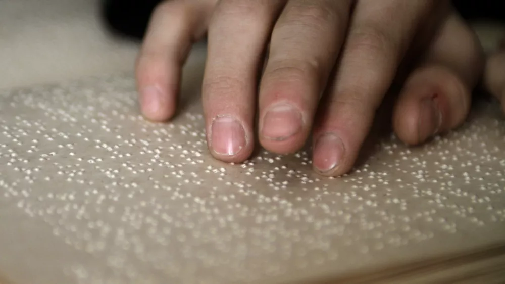 A blind boy reads a Braille book in a classroom in Tbilisi March 19, 2010. Forty-seven children study and live at the only boarding school for blind children from the age of 6 to18 years old in Georgia. REUTERS/David Mdzinarishvili (GEORGIA - Tags: EDUCATION SOCIETY)