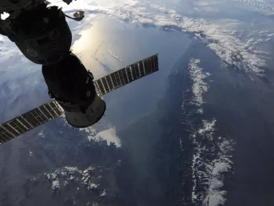 In this image provided by NASA shows the view out of the Cupola window shows the Soyuz 23S, "Olympus" module docked to the nadir side of the International Space Station taken by astronaut Douglas Wheelock as the space station was passing over the majestic snow-capped Caucuses. The sun rising and reflecting off the Caspian Sea. (AP Photo/NASA - Douglas Wheelock)