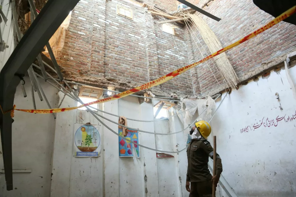 A rescue staff stands in a classroom after a school roof collapse in Peshawar, Pakistan, October 15, 2026. REUTERS   TPX IMAGES OF THE DAY