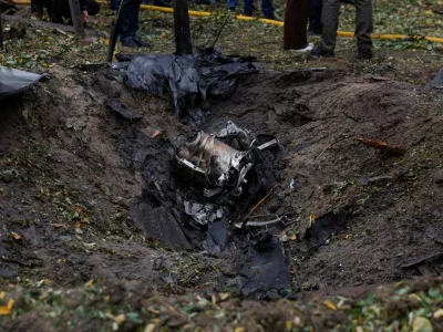 Wreckages of a Russian jet powered drone lay inside a crater that appeared at the site of a residential area after a strike, amid Russia's attack on Ukraine, in Kyiv, Ukraine October 15, 2026. REUTERS/Valentyn Ogirenko