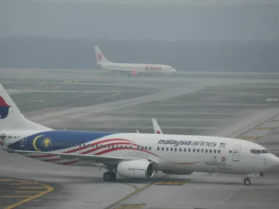 Malaysia Airlines and Lion Air aircraft on the haze-shrouded tarmac at Kuala Lumpur International Airport in Sepang, Malaysia, October 14, 2026. REUTERS/Hasnoor Hussain