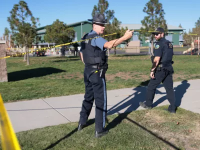 An emergency worker holds up police tape at the scene of a shooting at Silver Rail Elementary School in Bend, Oregon, US, October 15, 2026. REUTERS/Rob Kerr