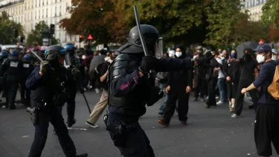French CRS riot police raise batons towards protesters amid clashes at the Place de la Nation during a demonstration by high school and university students, supported by teachers' union and school parents, in Paris as part of a nationwide day of protests and blockades, voicing anger over overcrowded classrooms, teacher shortages and dilapidated school buildings, which students blame on years of underinvestment, France, October 6, 2026. REUTERS/Abdul Saboor