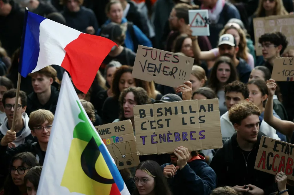 A protester holds a placard reading "Bismillah c'est les tenebres" (Bismillah, it's darkness) during a demonstration by French high school and university students in Nantes as part of a nationwide protest movement led by students, supported by teachers, school parents and labour unions, demanding better school conditions and concrete measures, France, October 13, 2026. REUTERS/Stephane Mahe